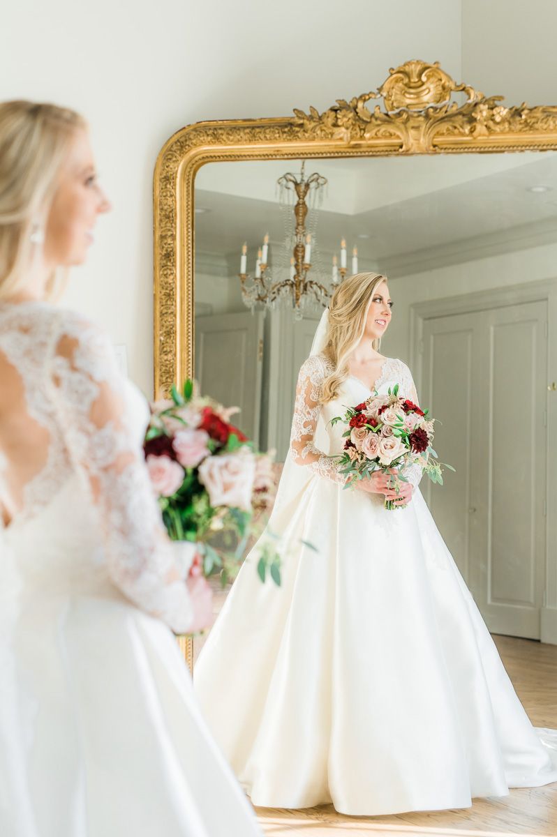bride looking in mirror during bridal session 