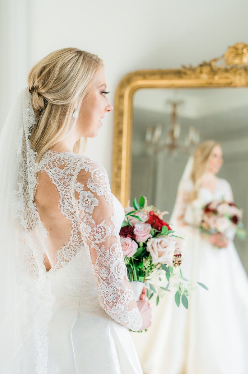 bride looking in mirror during bridal session 