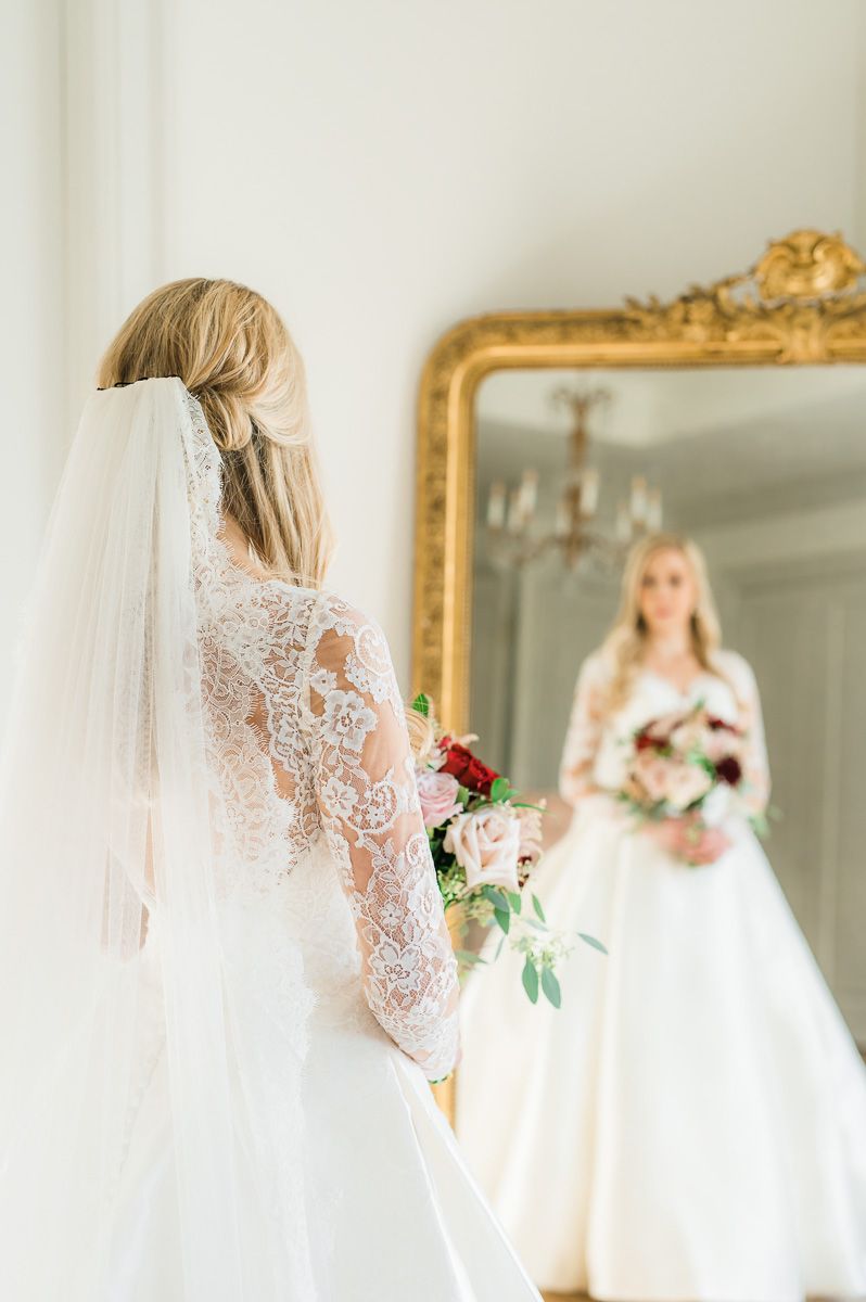 bride looking in mirror during bridal session 