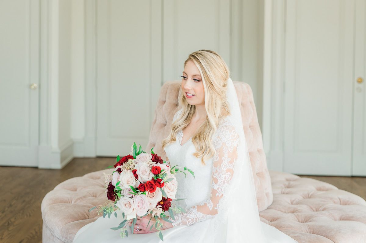 bride sitting on pink sofa