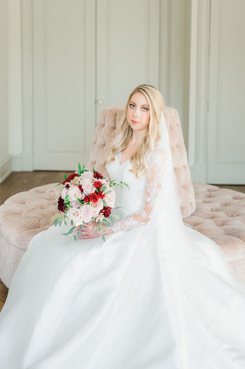 bride sitting on pink sofa