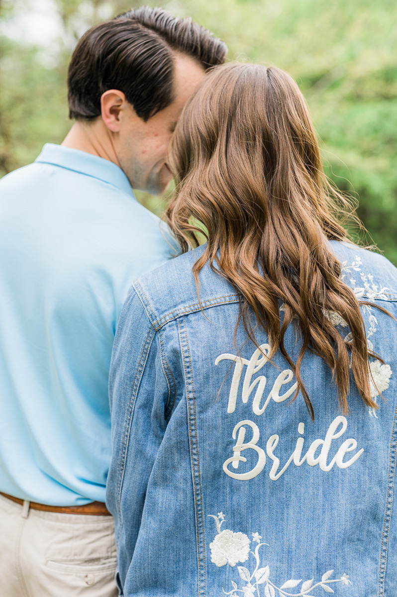 bride wearing a jean jacket that says The Bride