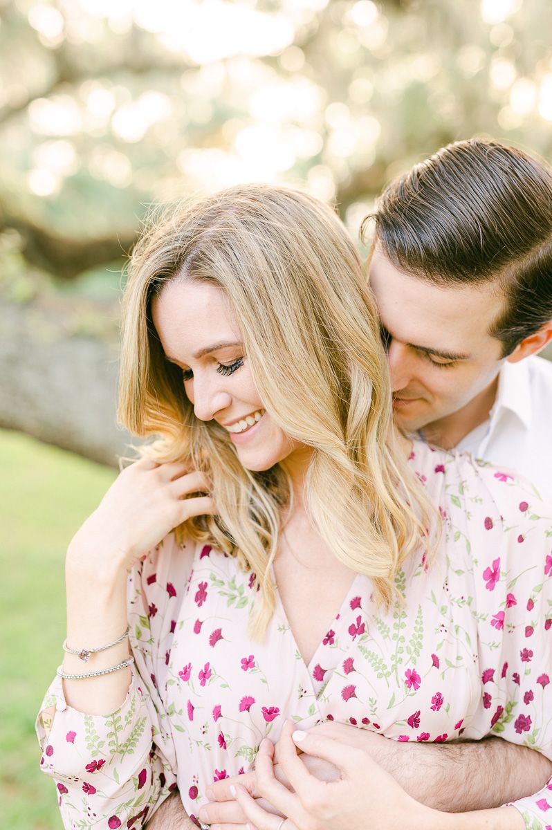 couple cuddling near tree in Brazos Bend State Park