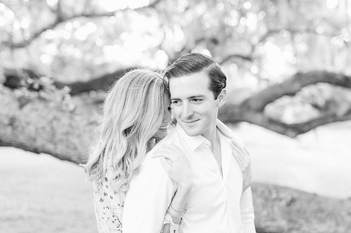 couple cuddling near tree in Brazos Bend State Park
