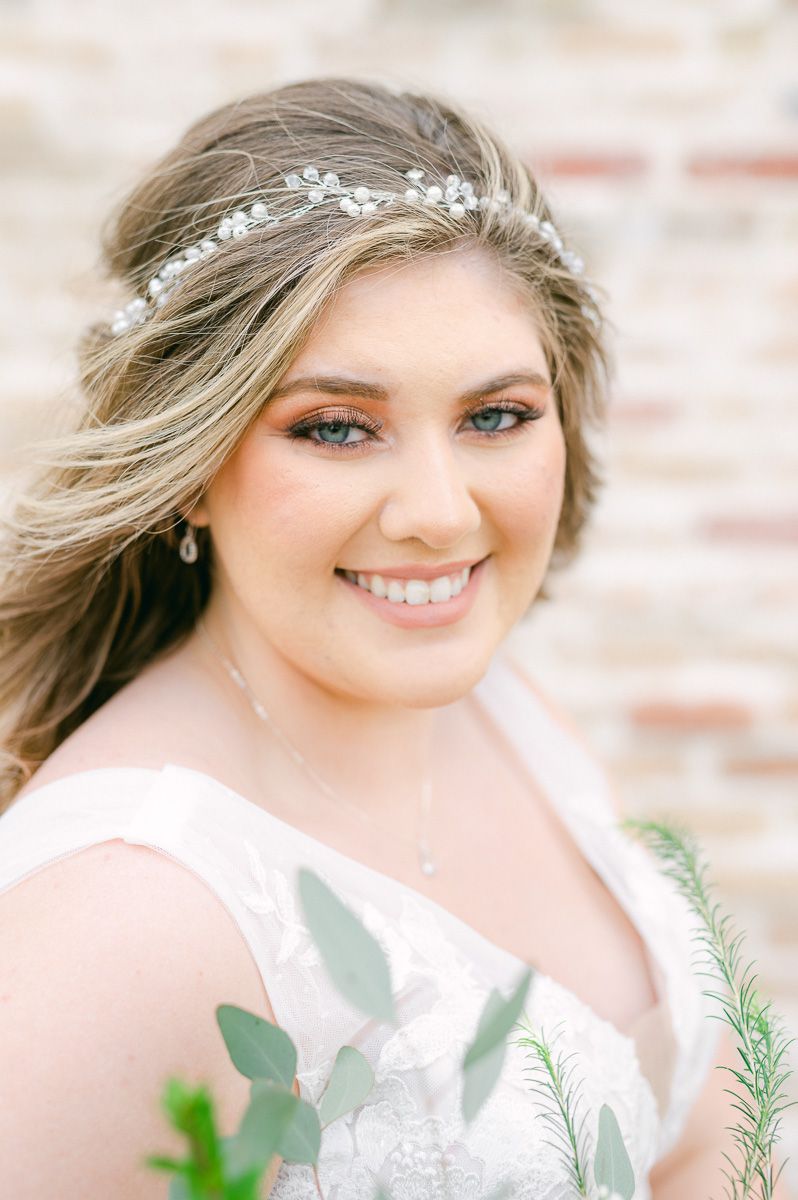 bride in front of brick wall