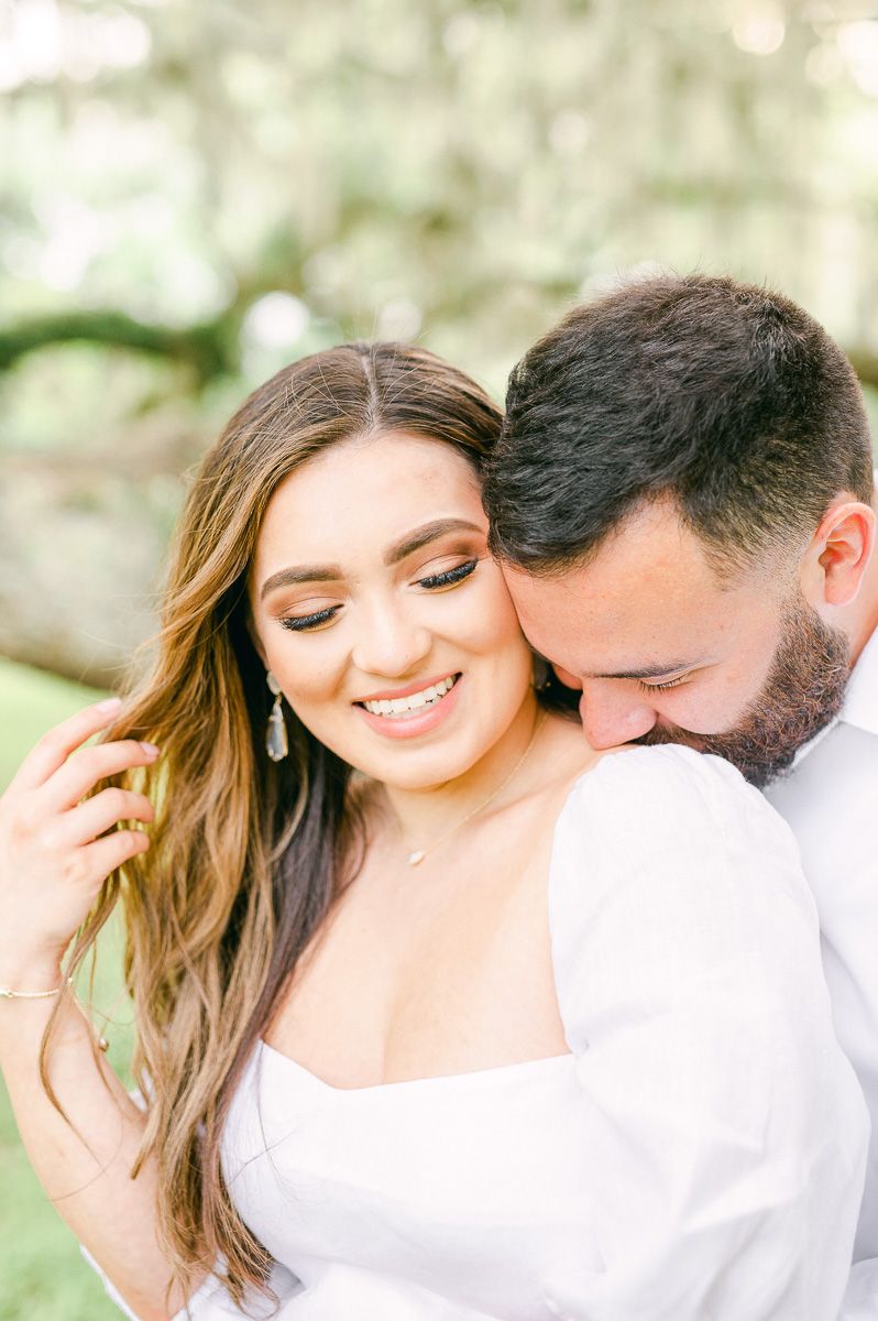 couple cuddling at engagement photo session
