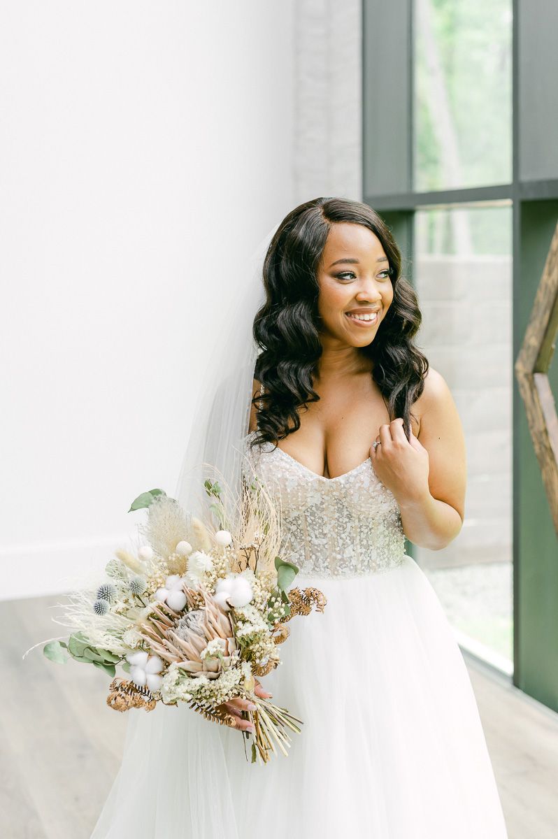 bride holding natural wedding bouquet
