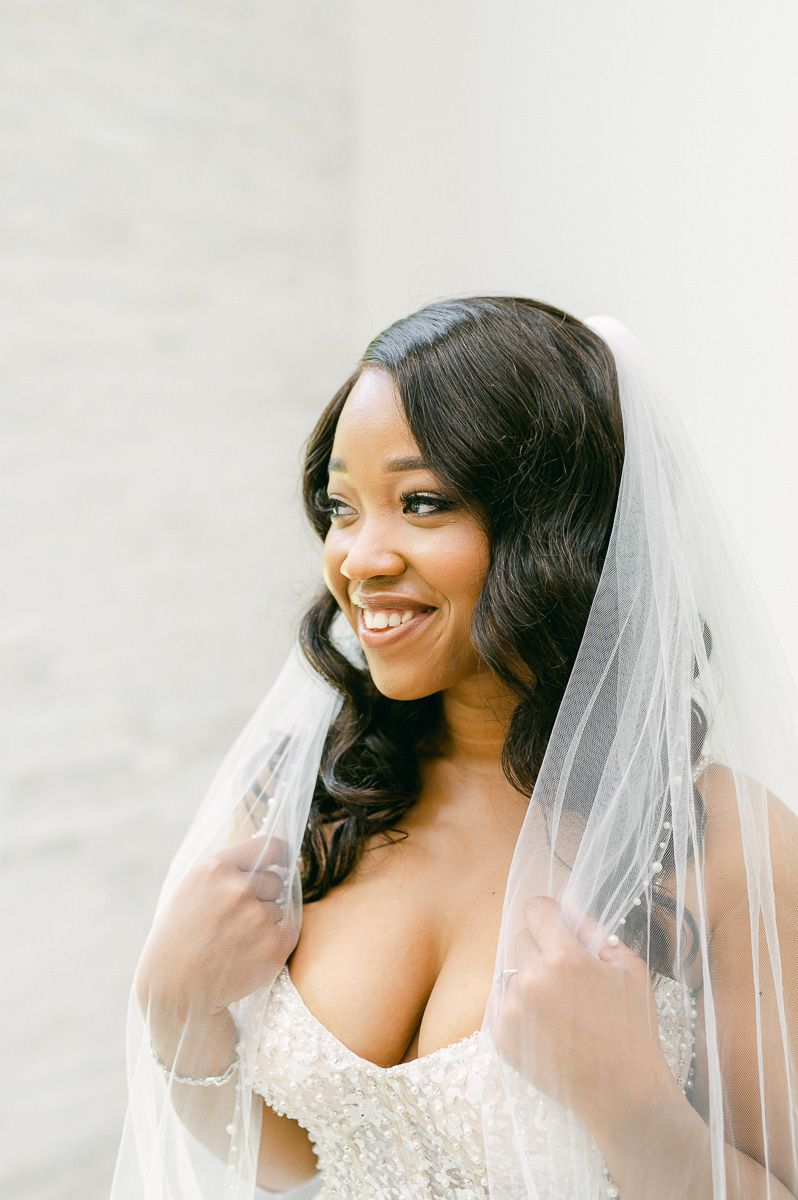 bride holding her veil at Conroe wedding venue