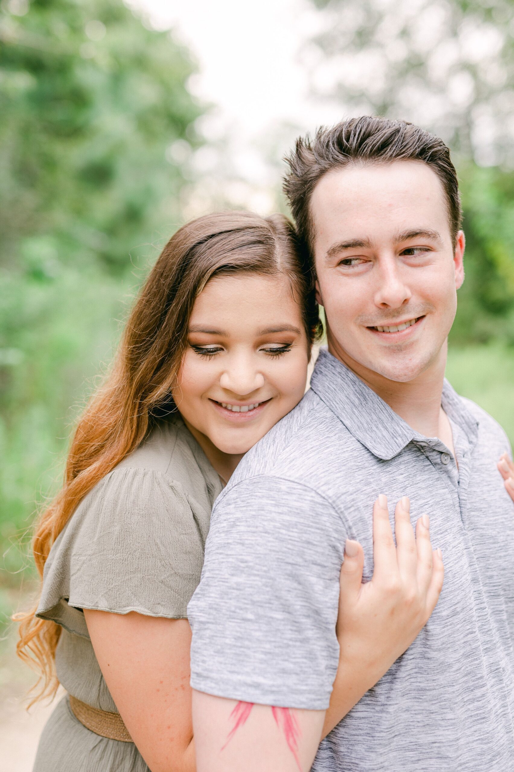 couple cuddling at engagement session in houston