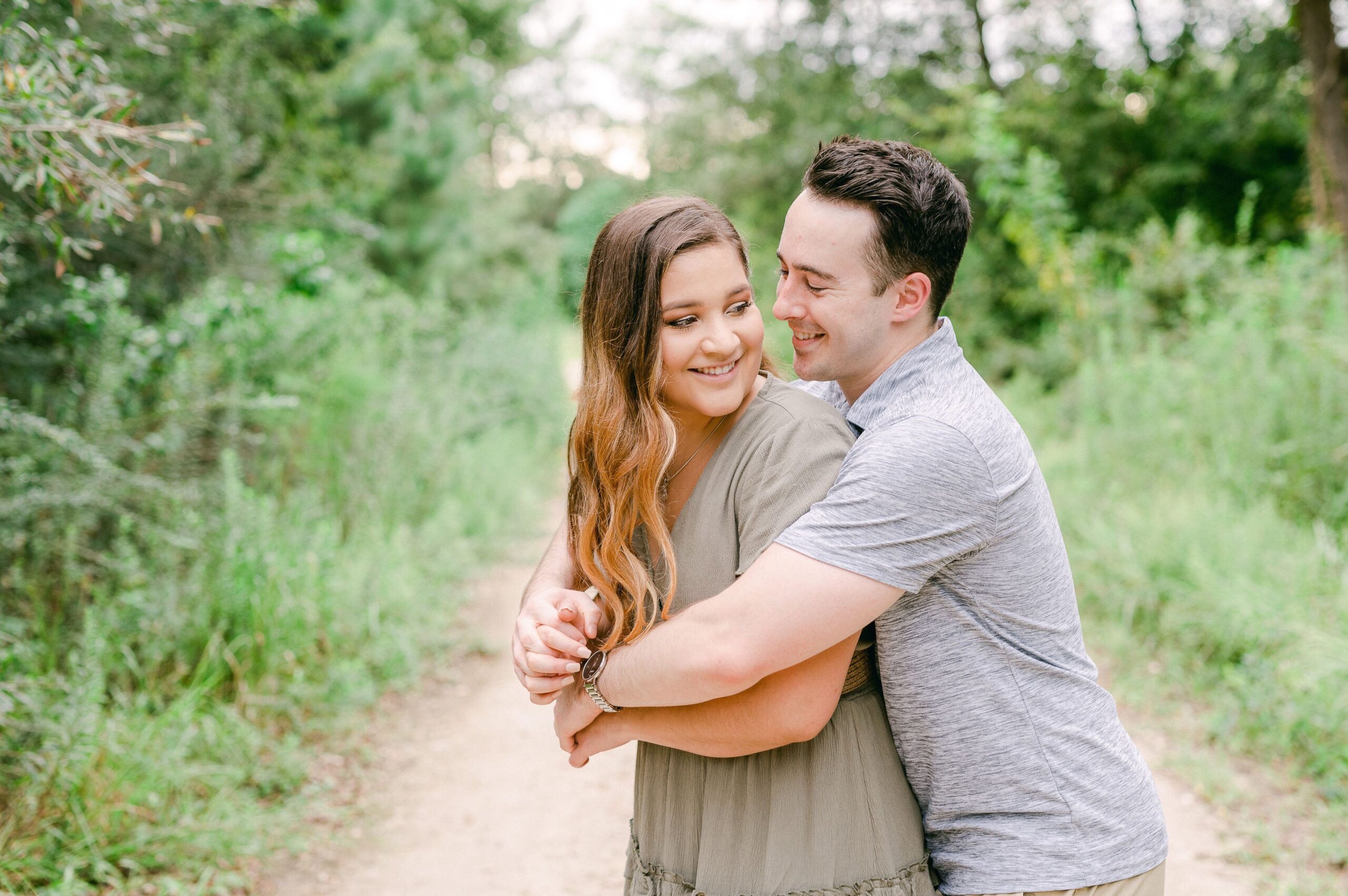couple cuddling at engagement session in houston