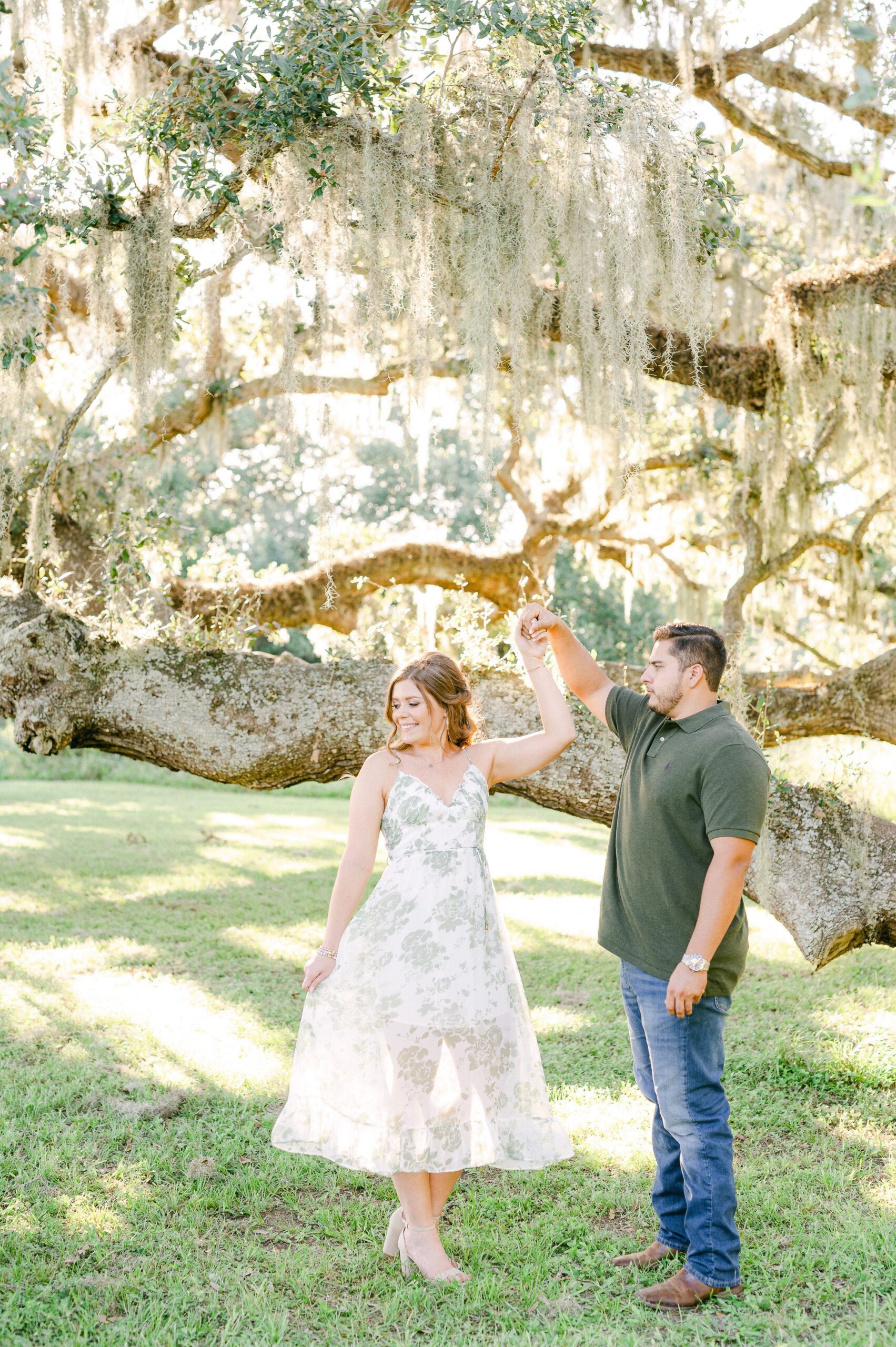 couple at engagement session under Spanish Moss tree