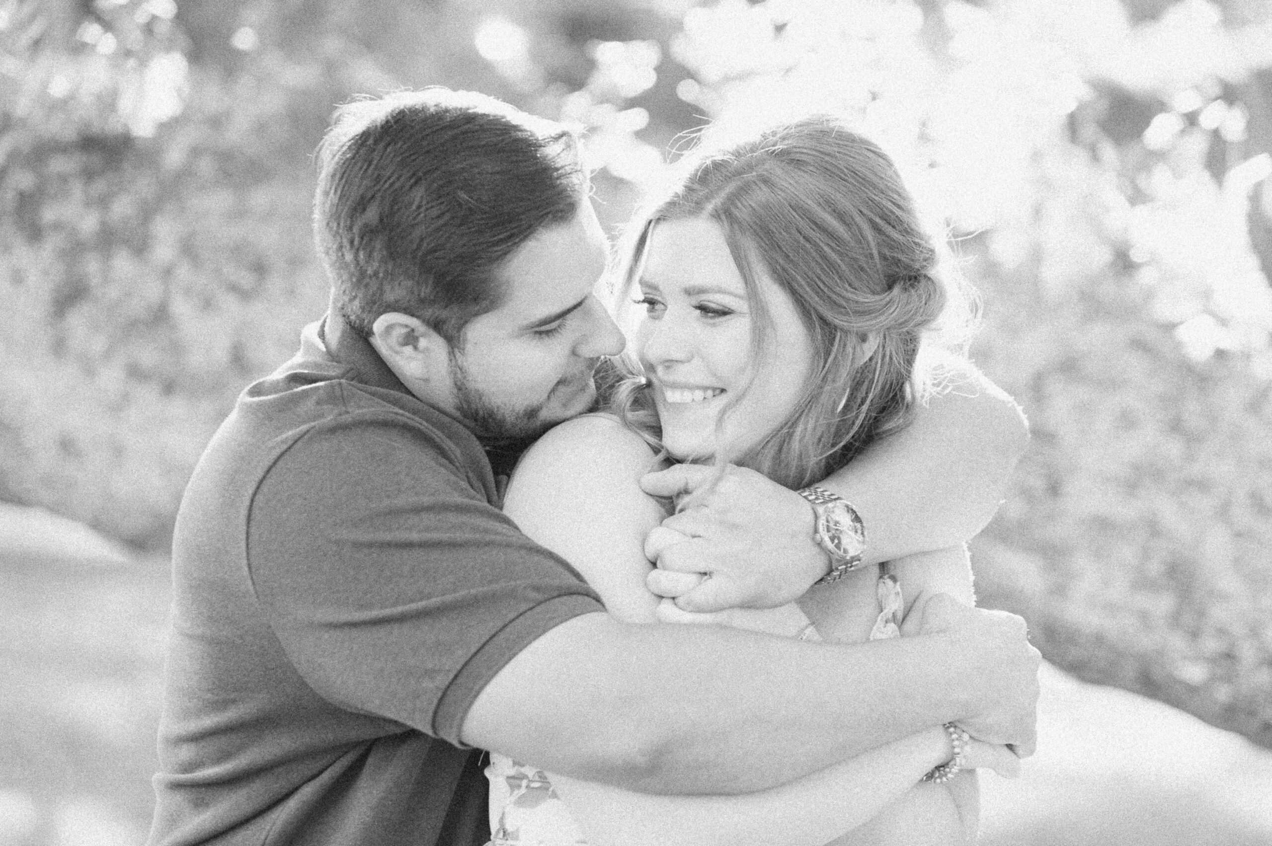 couple cuddling during engagement photos