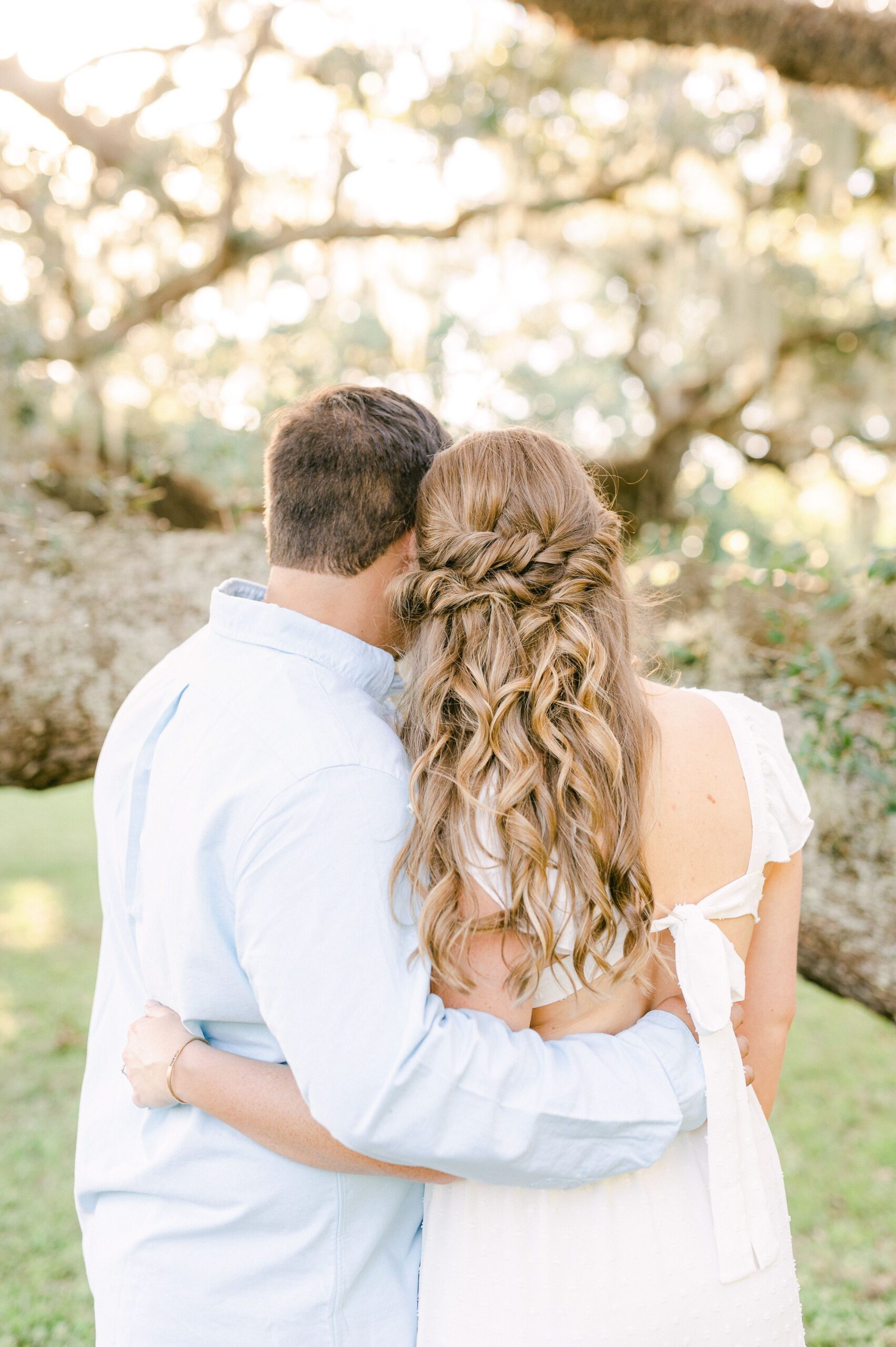 couple cuddling during engagement photos