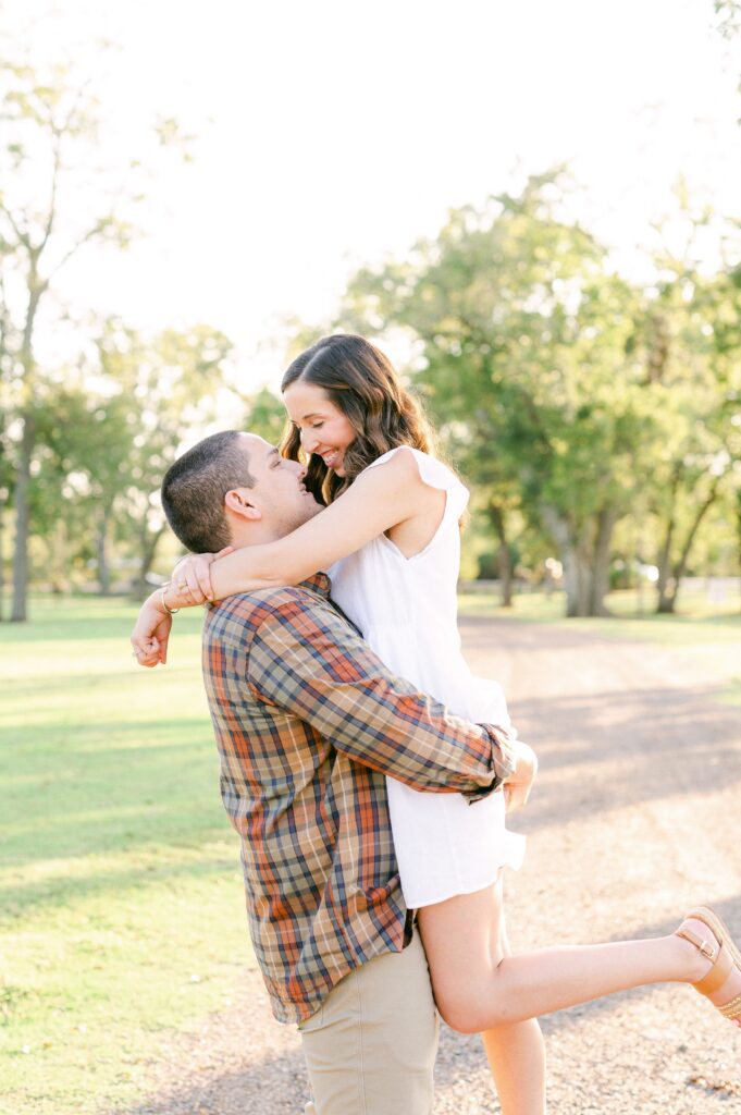 groom picking up bride during engagement session