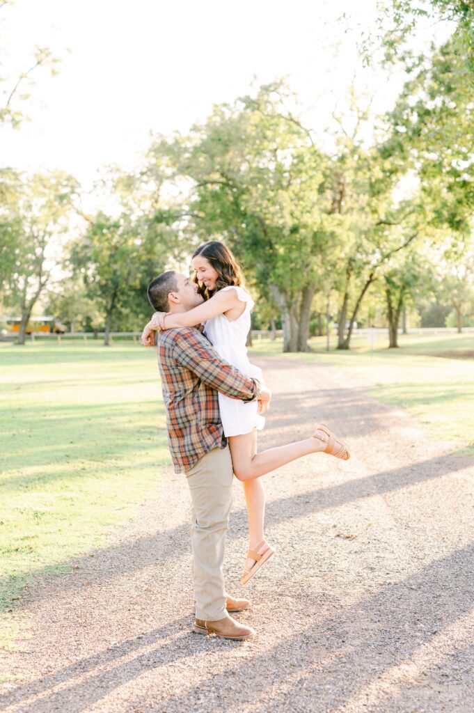 groom picking up bride during engagement session