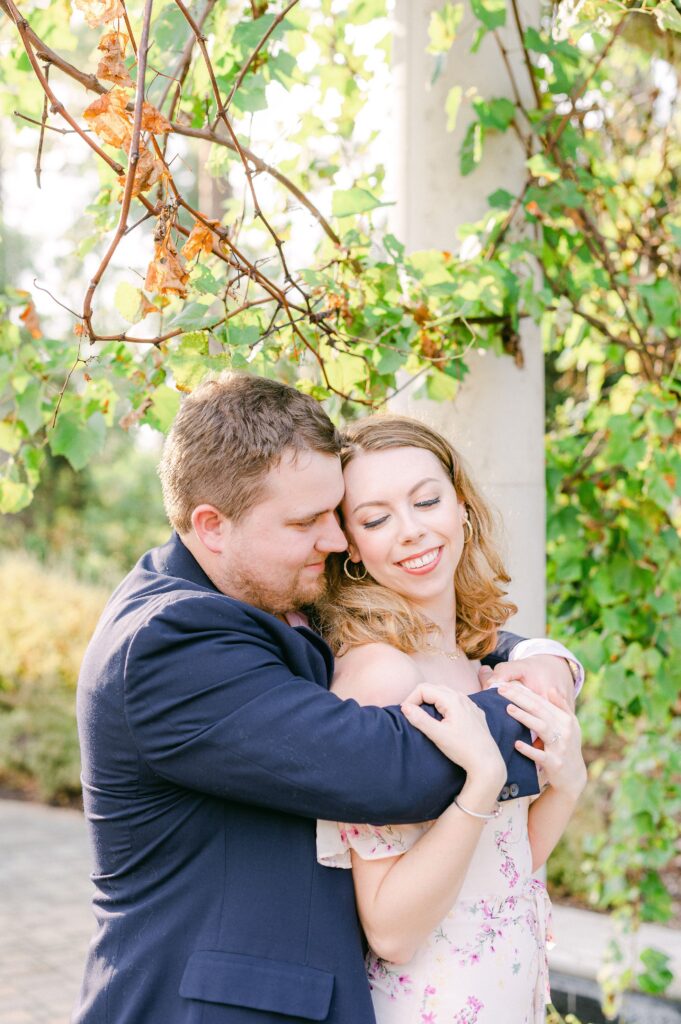 couple cuddling during engagement session in Houston