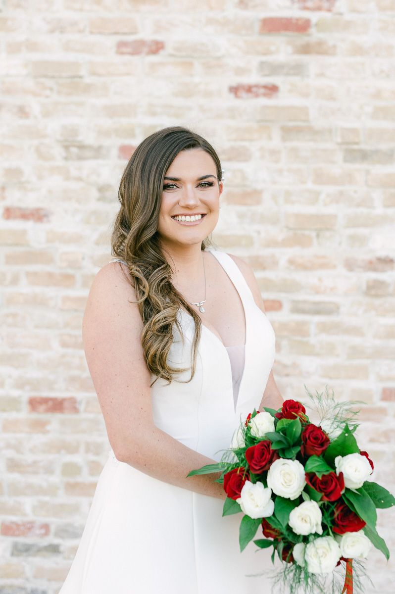 bride with red and white rose bouquet