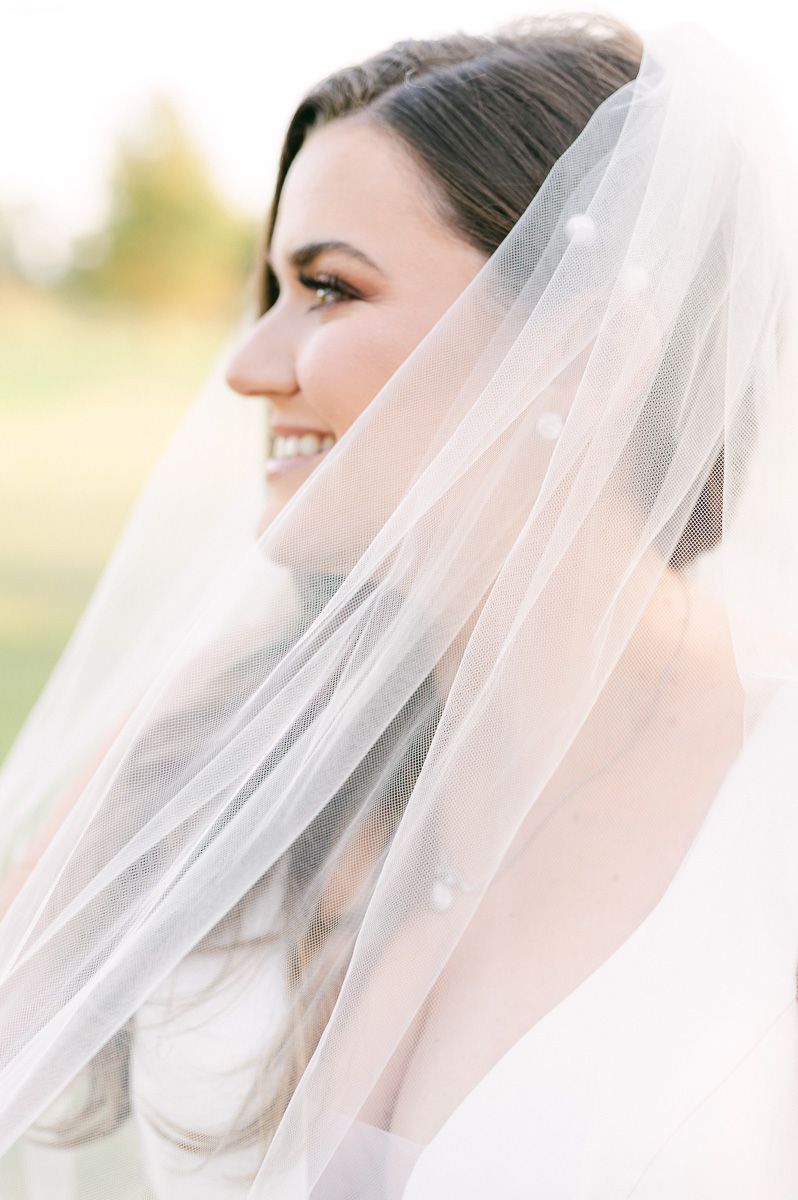 bride holding her veil in Katy, Tx