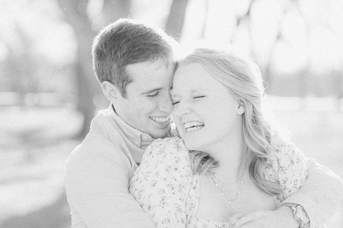 black and white photo of couple cuddling