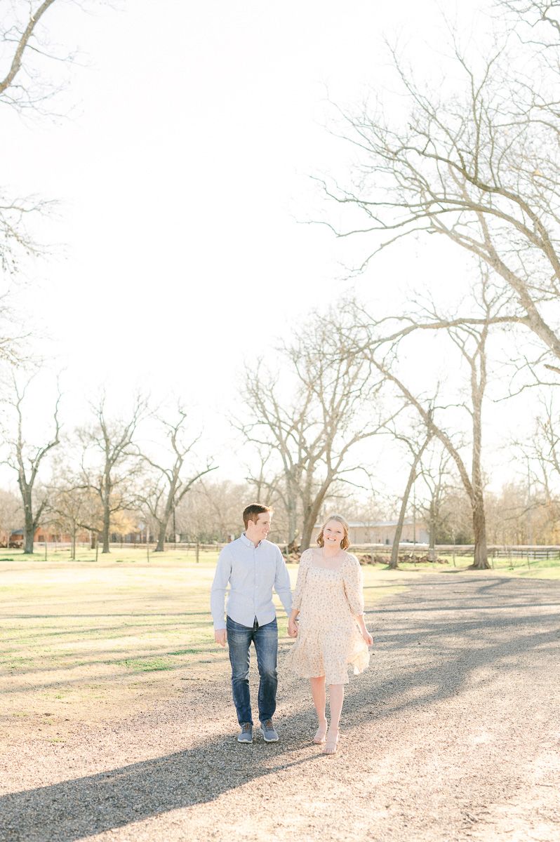 Engaged couple walking in Richmond, Tx