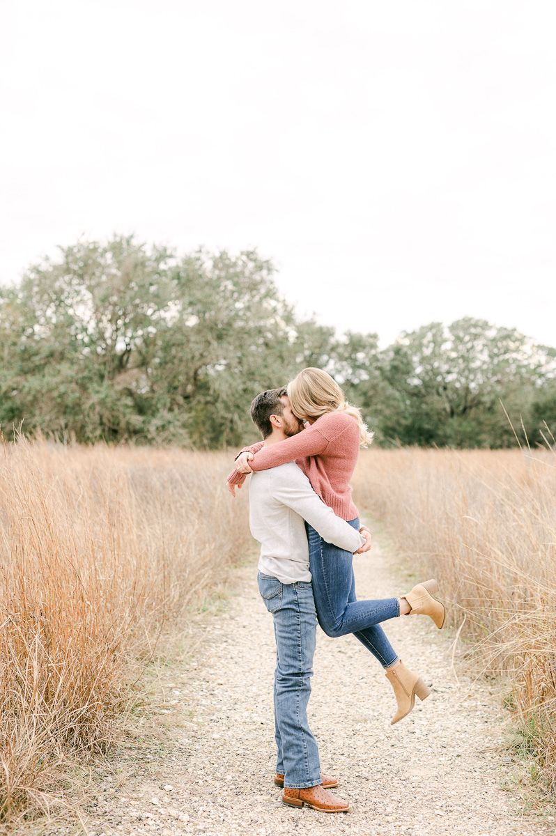 Groom picking up bride during engagement session