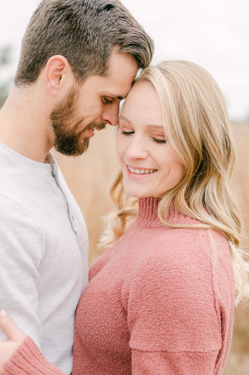 Engaged couple cuddling during engagement session