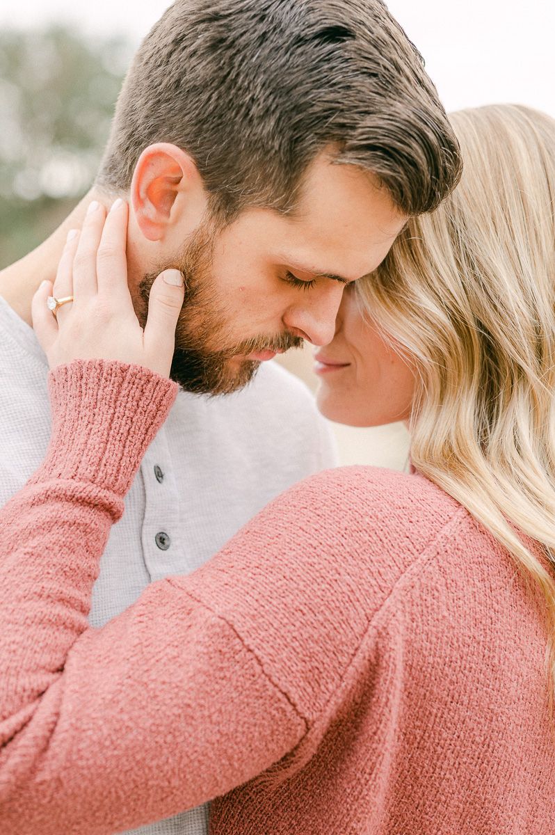 Engaged couple cuddling during engagement session