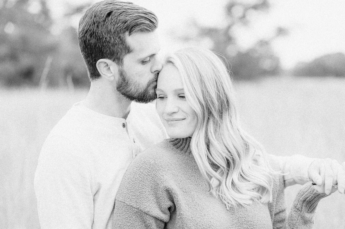 Engaged couple cuddling during engagement session