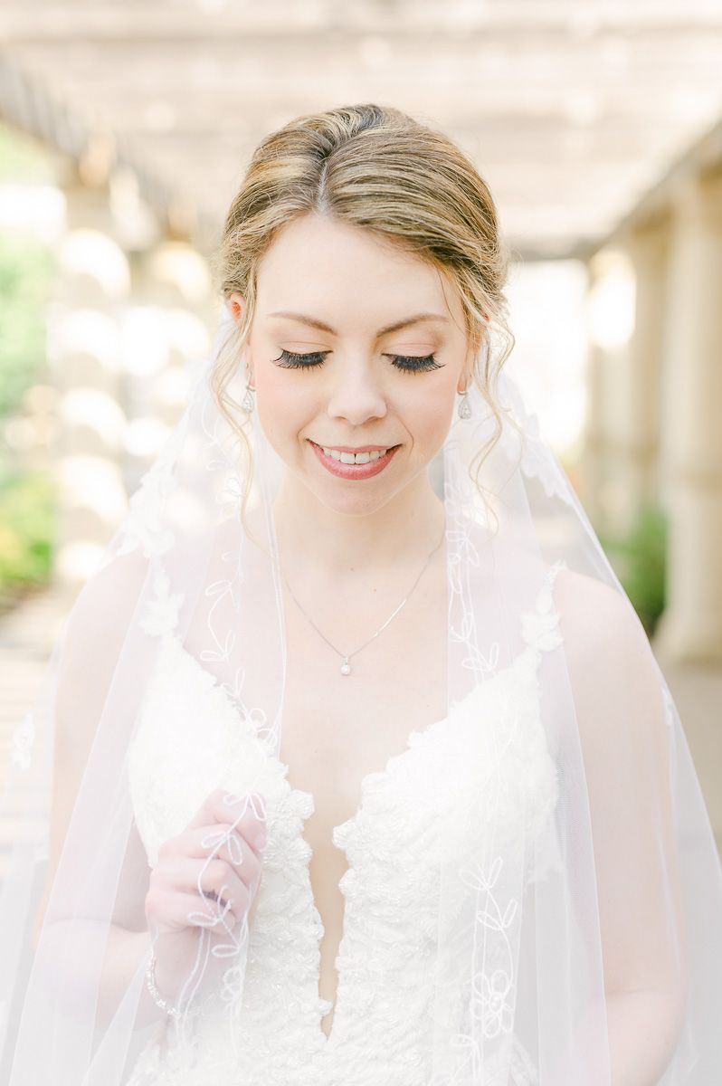 Bride holding veil at Ashton Gardens North Houston bridal session