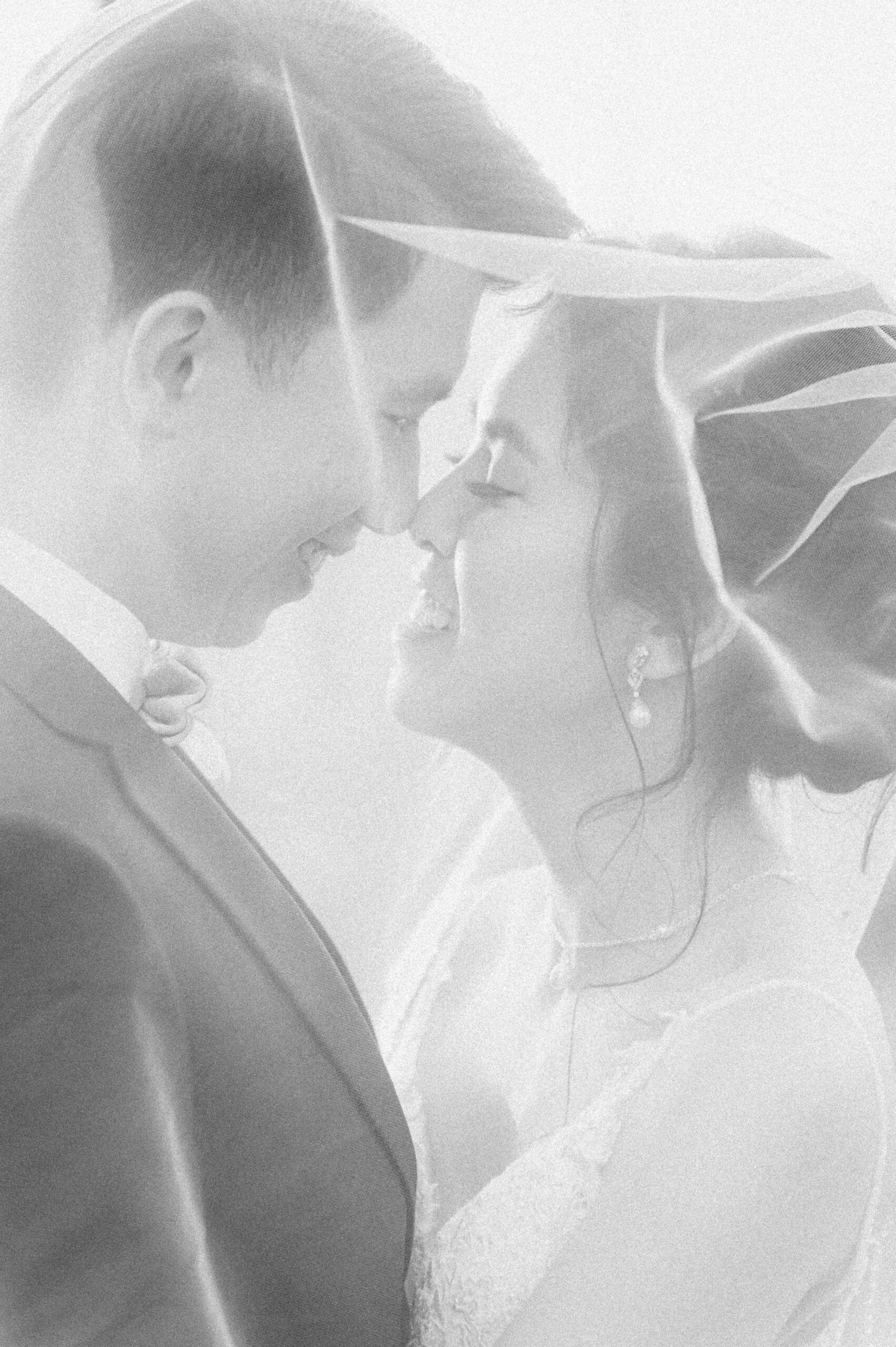 bride and groom under veil at Houston wedding