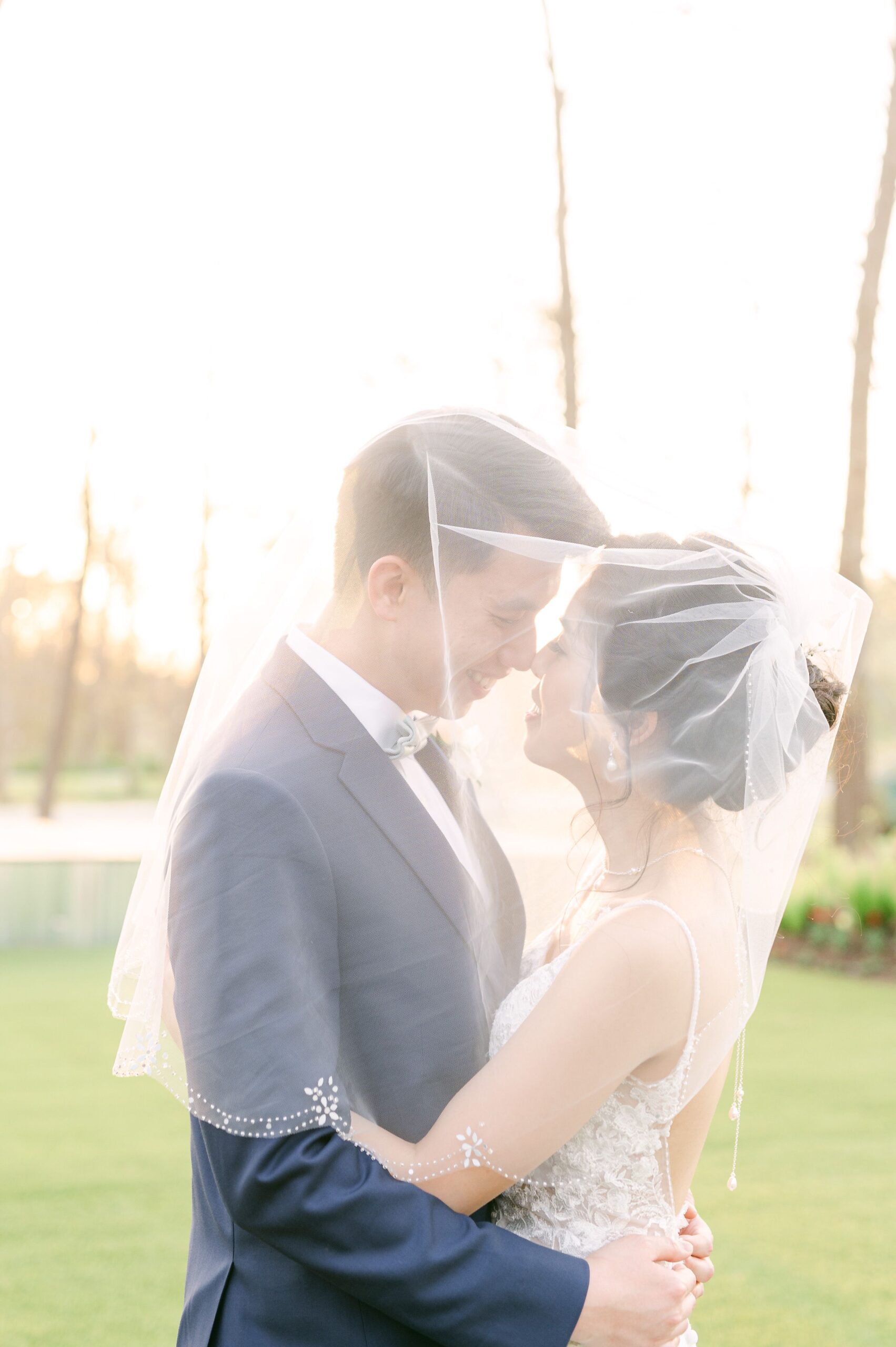 bride and groom under veil at Houston wedding