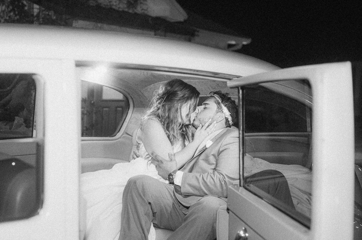 couple kissing inside classic car