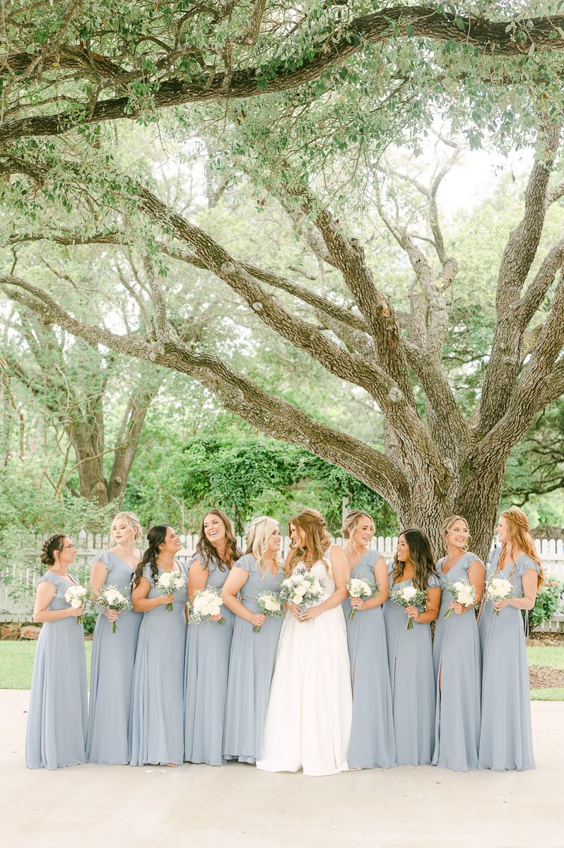 bridesmaids in blue under large tree in Pattison, Tx