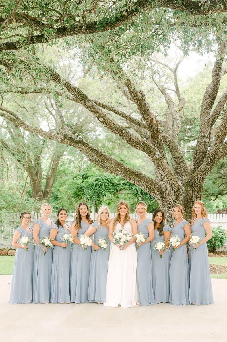 bridesmaids in blue under large tree in Pattison, Tx