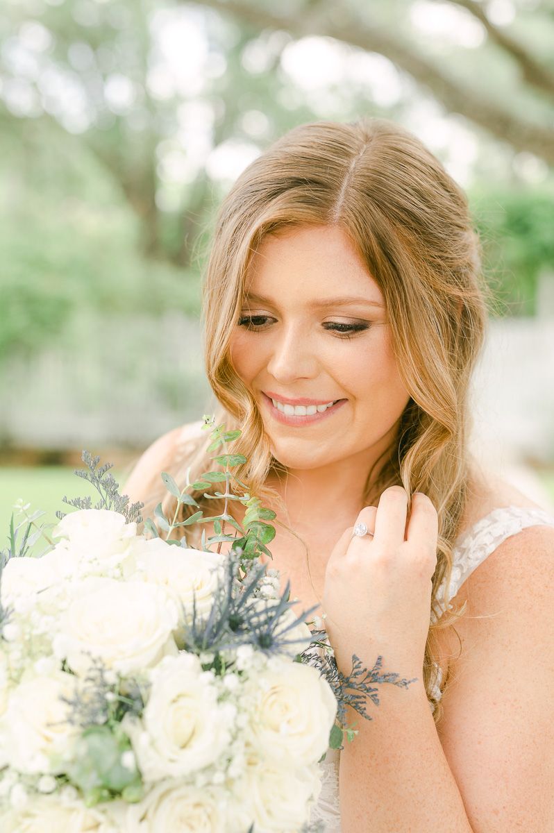 bride in blue under large tree in Pattison, Tx