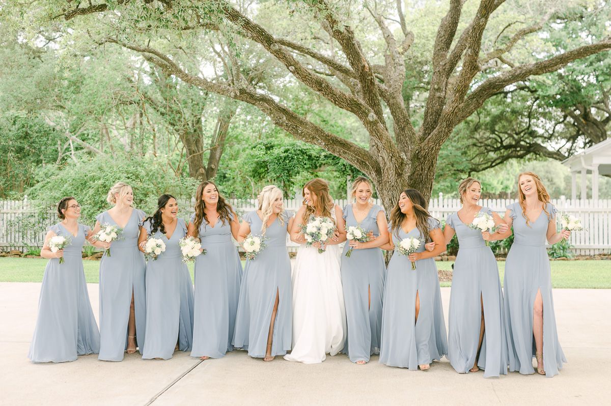 bridesmaids in blue under large tree in Pattison, Tx