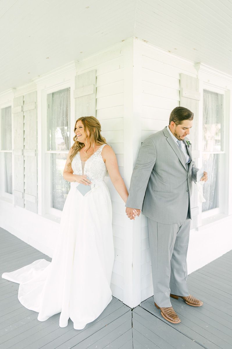 first touch between bride and groom on porch at The Pattison House