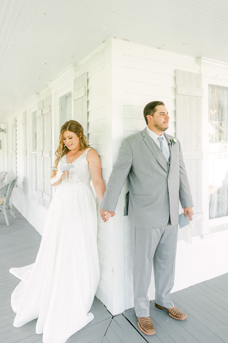 first touch between bride and groom on porch at The Pattison House