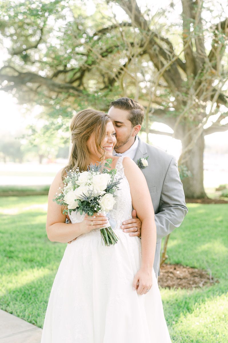 bride and groom under large tree in Pattison, Tx