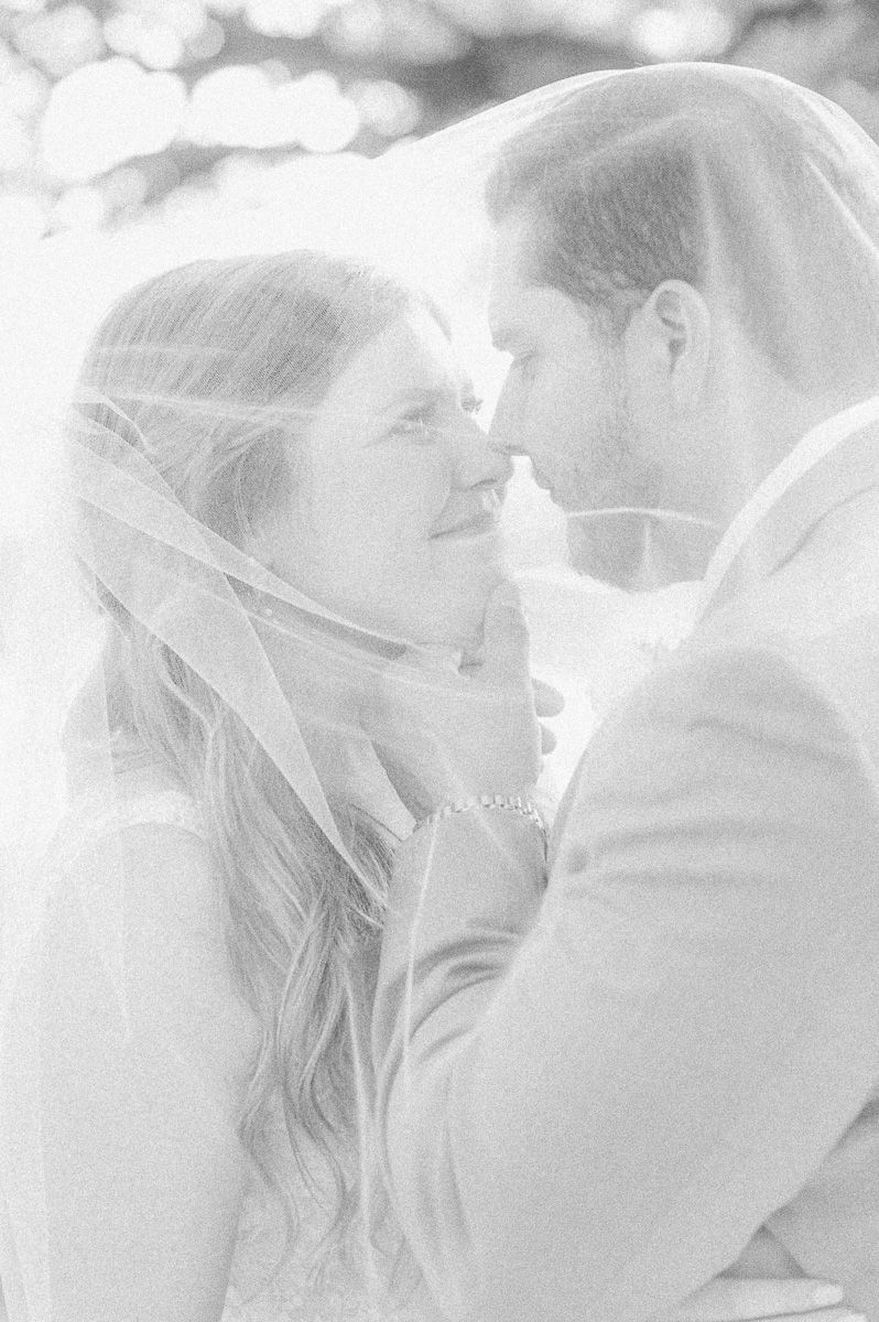 black and white bride and groom under veil