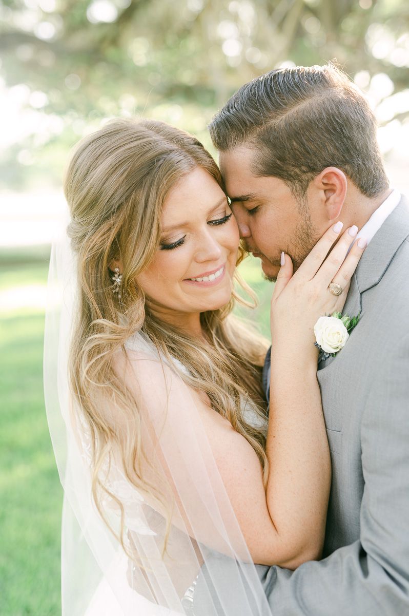 bride and groom under large tree in Pattison, Tx