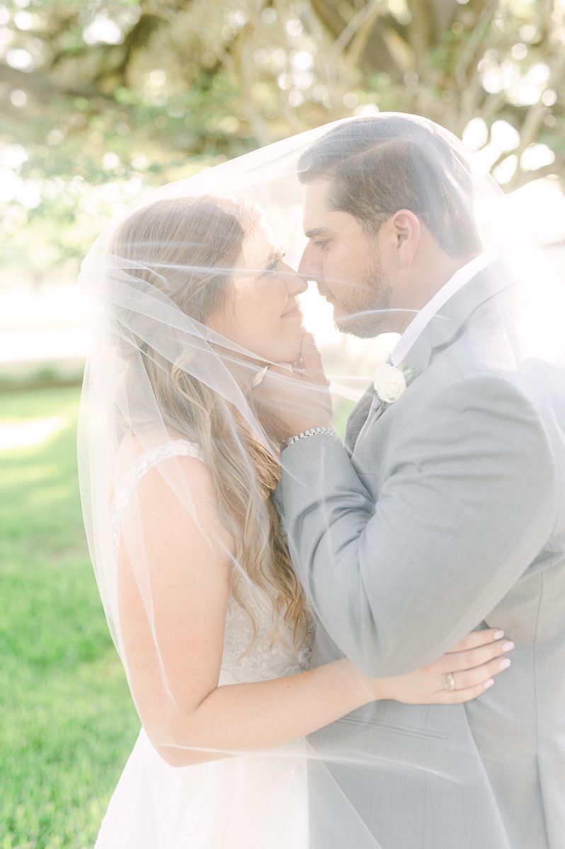 bride and groom under veil in Pattison, Tx