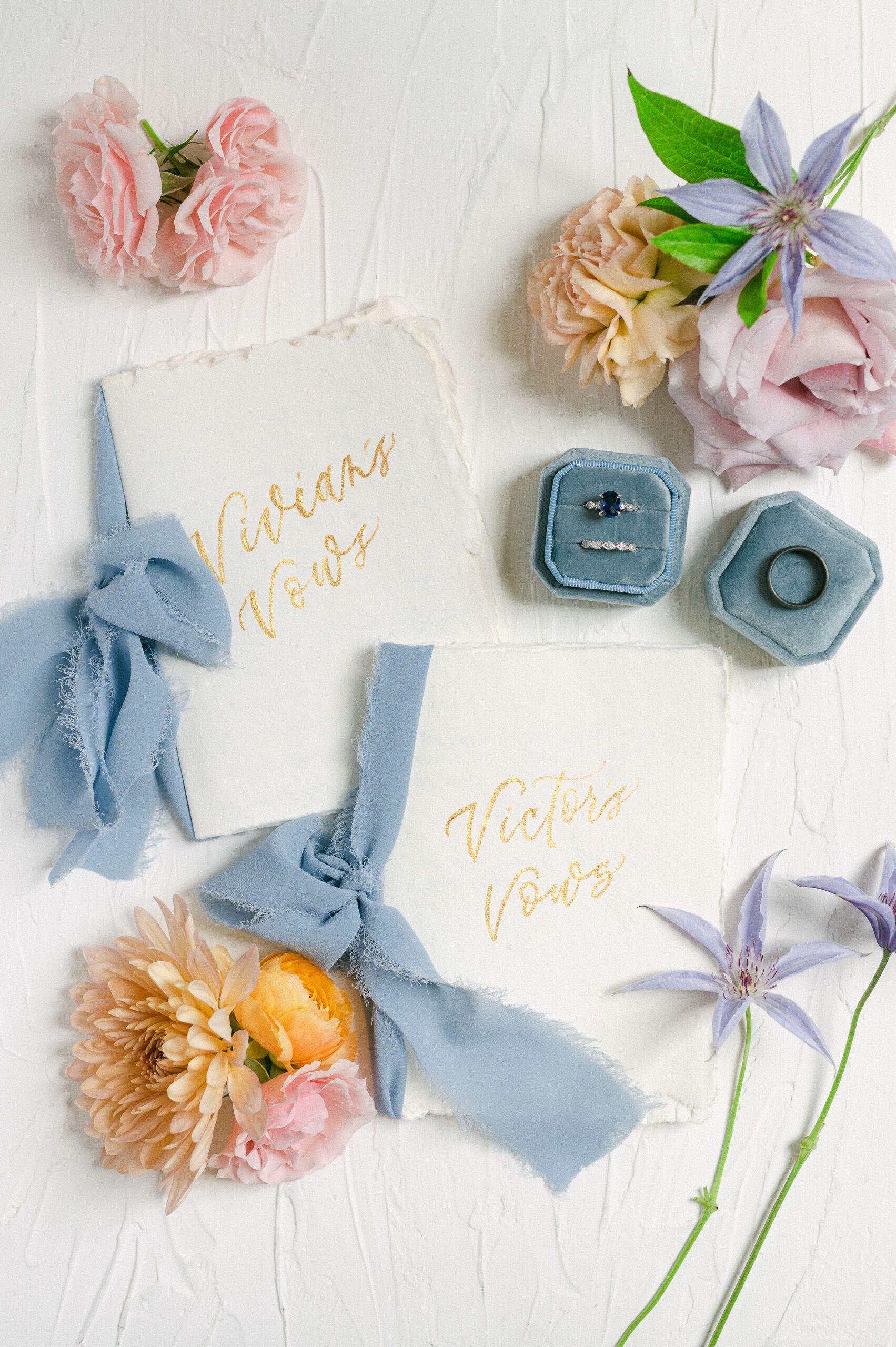 vow books with blue ribbon and colorful flowers