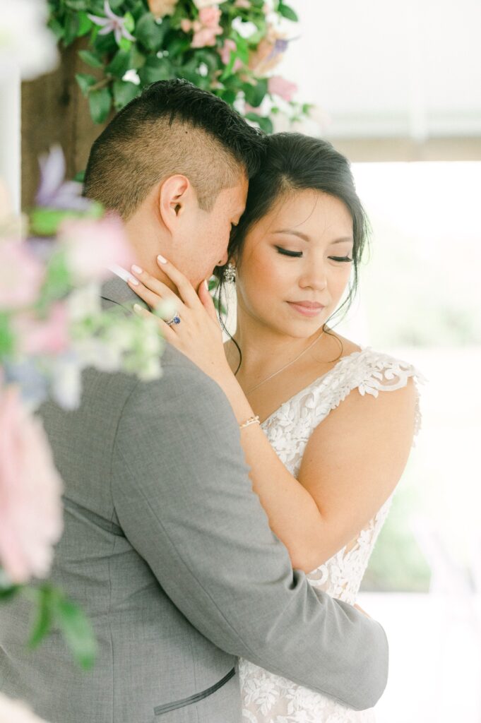 bride and groom cuddling at spring wedding