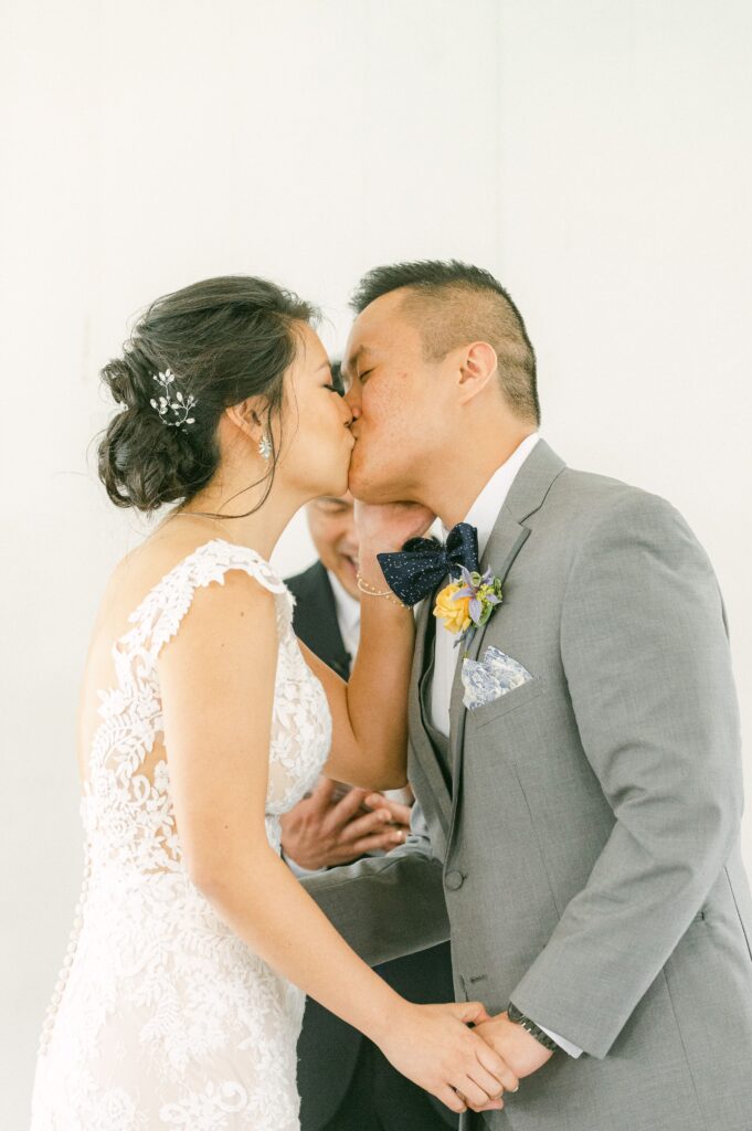 couple kissing at ceremony