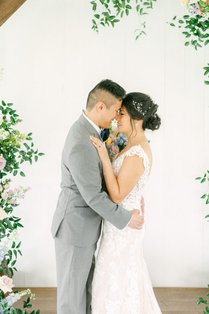 bride and groom cuddling at spring wedding