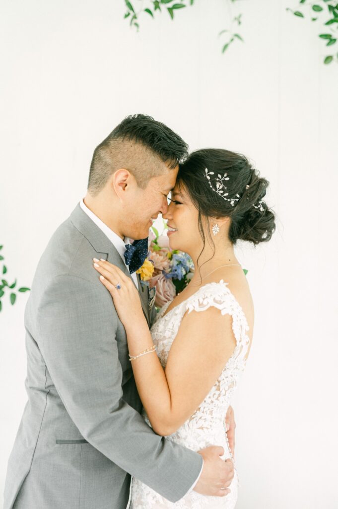 bride and groom cuddling at spring wedding