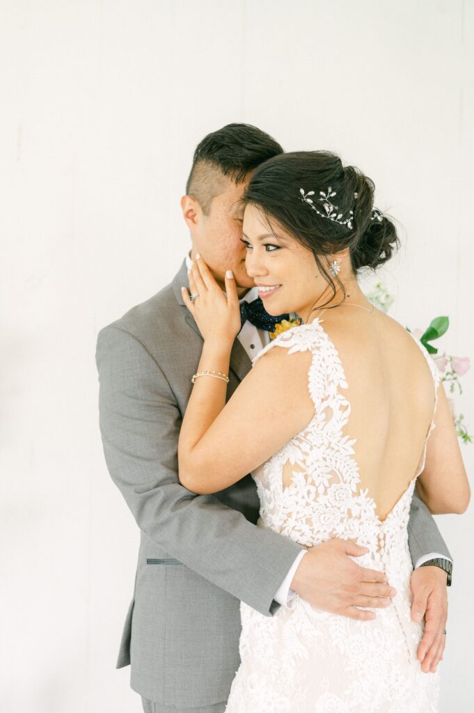 bride and groom cuddling at spring wedding