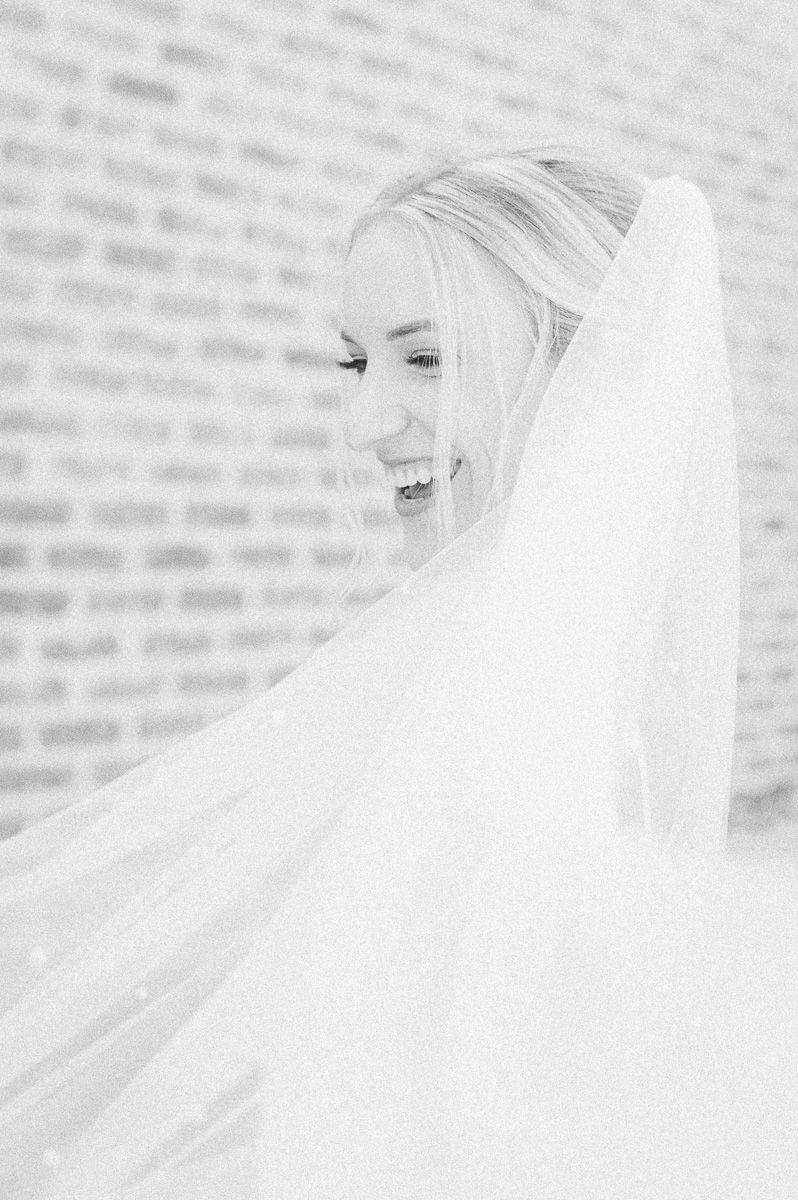 black and white photo of bride laughing