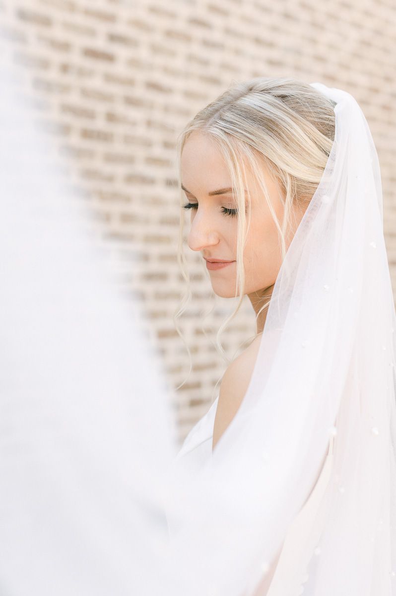 bride with veil flowing at camera